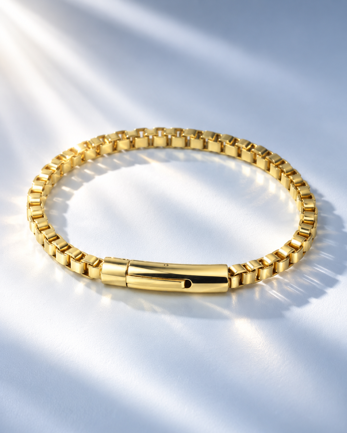 Men's stainless steel box link chain bracelet, 18K gold plated, styled in sunlight
