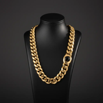 Men’s 18K gold Miami Cuban link chain's box clasp with a central gemstone a black mannequin 