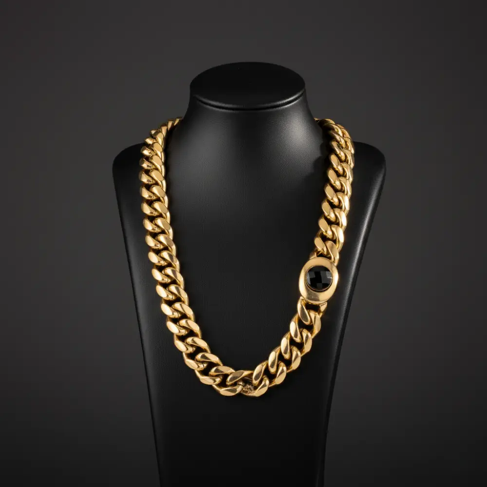 Men’s 18K gold Miami Cuban link chain's box clasp with a central gemstone a black mannequin 