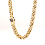 Men’s 18K gold Miami Cuban link chain's box clasp with a central gemstone