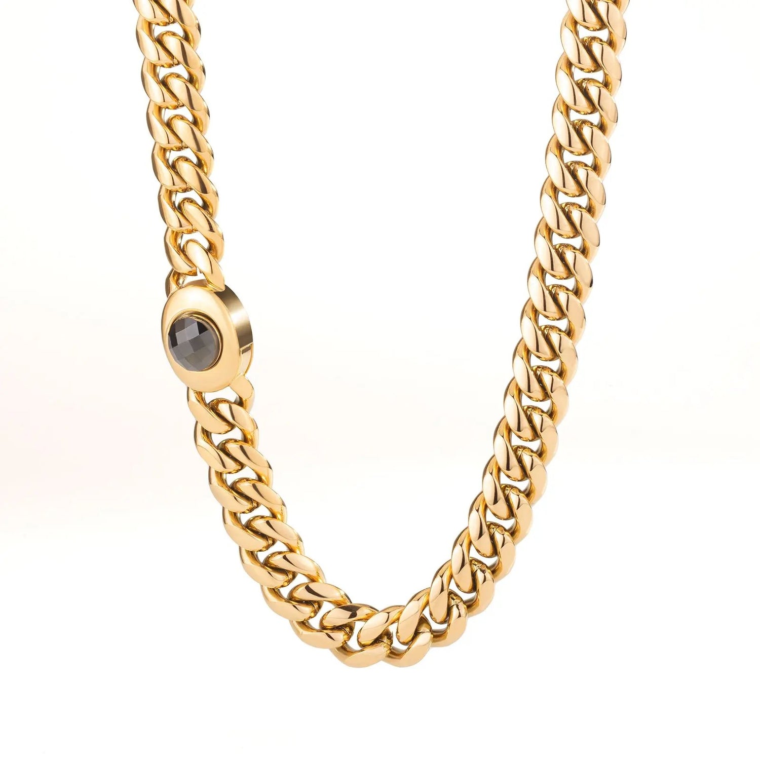 Men’s 18K gold Miami Cuban link chain's box clasp with a central gemstone