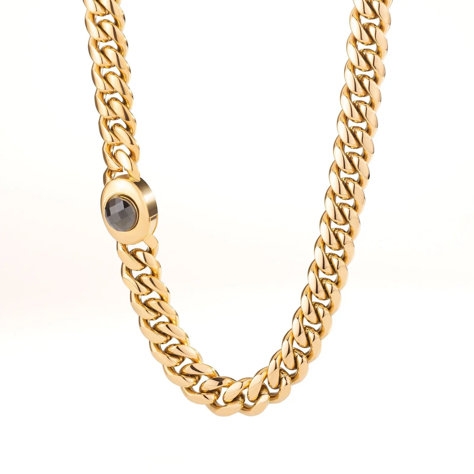 Men’s 18K gold Miami Cuban link chain's box clasp with a central gemstone