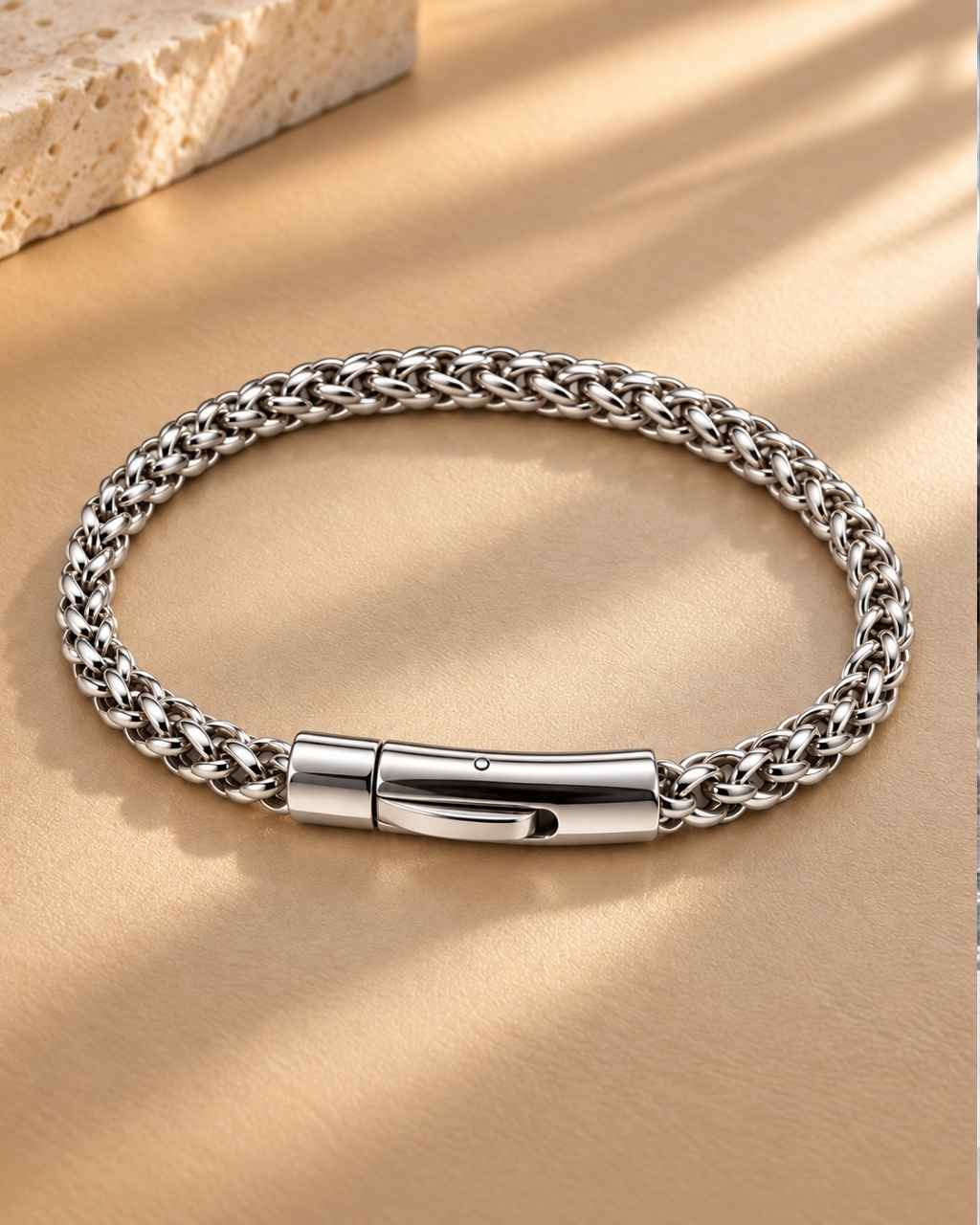 Men's stainless steel wheat link chain bracelet, rhodium plated, styled on leather background