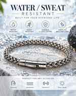 Men's stainless steel wheat link chain bracelet infographic, water and sweat resistant, durable, shown on wet stone surface